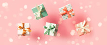 Polka Dot Pattern Gift Box With Ribbon Falling On Pink Background, Levitation