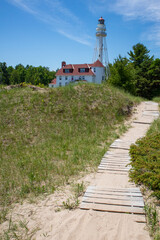 Rawley Point Lighthouse in Two Rivers, Wisconsin with a wooden path in July