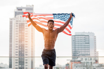 black lives matter concept, african american guy with usa flag shouting against city background, protest against racism