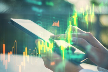 Aufkleber - Businessman hands using tablet with business statistics hologram.