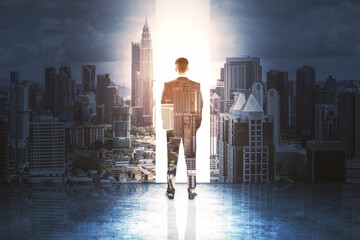 Wall Mural - Handsome businessman standing on abstract city background.