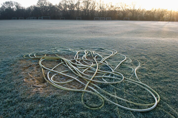 Wall Mural - Rope on empty soccer field sunset