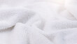Towel texture closeup. Soft white cotton towel backdrop, fabric background. Terry cloth bath or beach towels. Soft fluffy Textile. Macro, texture 