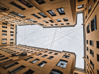 View of the sky from the yard house. Typical yard-well in St. Petersburg, Russia.