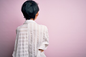 Wall Mural - Young beautiful asian girl wearing casual shirt standing over isolated pink background standing backwards looking away with crossed arms