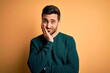 © Krakenimages.com - Young handsome man with beard wearing casual sweater standing over yellow background thinking looking tired and bored with depression problems with crossed arms.