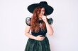 © Krakenimages.com - Young beautiful woman wearing witch halloween costume feeling unwell and coughing as symptom for cold or bronchitis. health care concept.