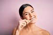 © Krakenimages.com - Young beautiful brunette woman brushing her teeth using tooth brush and oral paste, cleaning teeth and tongue as healthy health care morning routine