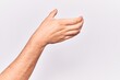 © Krakenimages.com - Close up of hand of young caucasian man over isolated background holding invisible object, empty hand doing clipping and grabbing gesture