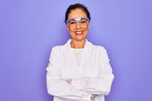 Middle Age Senior Scientist Woman Wearing Coat And Laboratory Glasses Over Purple Background Happy Face Smiling With Crossed Arms Looking At The Camera. Positive Person.