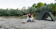 © Andrii Lysenko - Young mother explores beach with her daughter