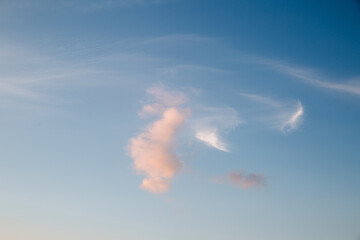 Wall Mural - the clouds in the sky are lit up by the rays of the setting sun