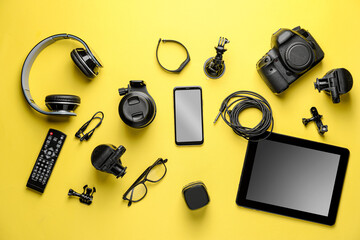 different modern devices on color background