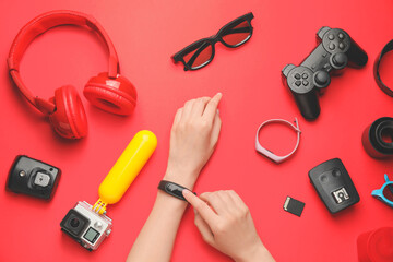 Female hands with different modern devices on color background