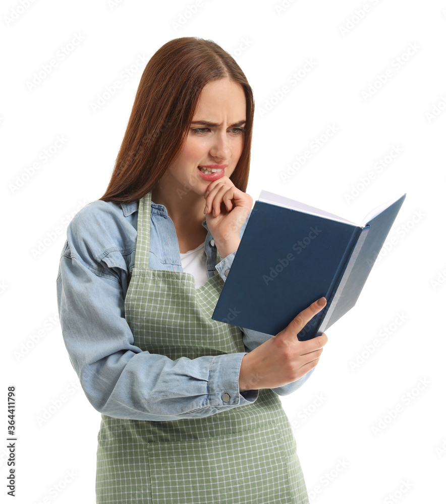 Young woman with recipe book on white background