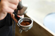 © Pixel-Shot - Young barista making coffee in cafe, closeup