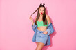 © deagreez - Photo of pretty flirty lady playing with long curl sending air kisses boyfriend wear denim jacket green crop top naked belly denim shirt isolated pastel pink color background