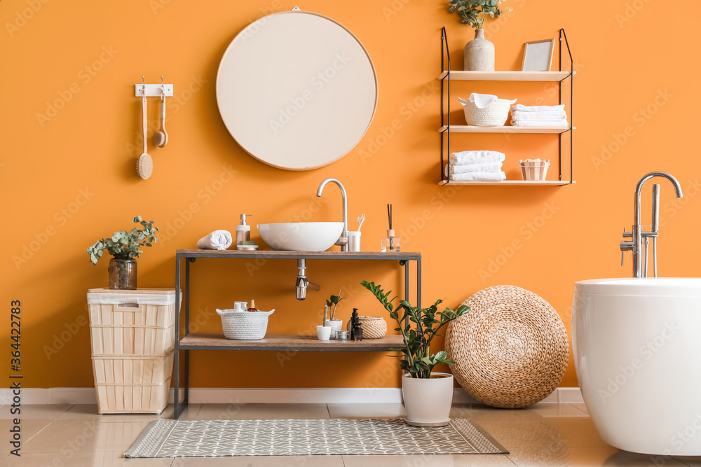 Stylish interior of modern bathroom with clean towels