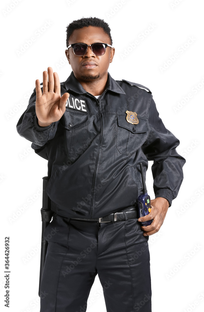 Aggressive African-American police officer on white background