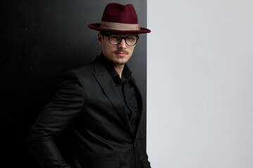 elegant fashion model with attitude, wearing a burgundy hat