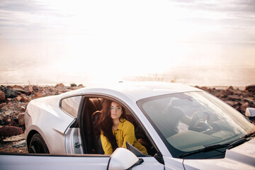 Wall Mural - Trendy young women traveling by car. Relaxed happy woman on summer roadtrip travel vacation