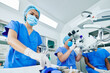 © DragonImages - Surgeon working on modern equipment when his assistant preparing tools and medical supplies