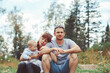 © venerala - family with children sitting on the river Bank