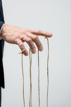Partial View Of Puppeteer With Strings On Fingers Isolated On Grey