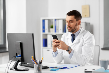 Canvas Print - healthcare, medicine and people concept - male doctor with smartphone at hospital