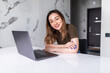 © dianagrytsku - Young beautifu asian woman with laptop at kitchen