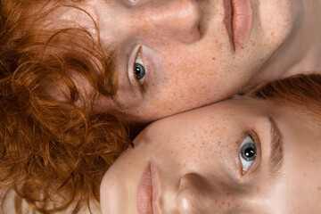 faces. fashion portrait of beautiful redhead couple isolated on grey studio background. concept of m