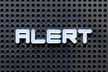 Sticker - White color alphabet with word alert on black pegboard background