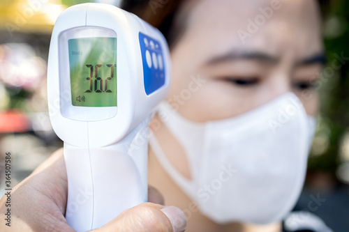 Measures to prevent people with fever,Coronavirus,against the spread of COVID-19,wear face mask and screening point using infrared thermometer,check body temperature without contact,New normal life