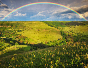  Beautiful landscape with a rainbow in the sky