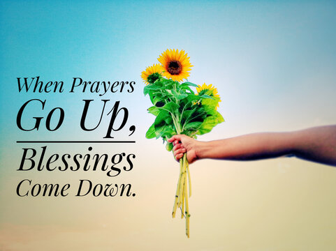 Wall Mural -  - Inspirational quote - When prayers go up, blessings come down.  With hand holding bouquet of sunflowers against bright blue sky background. Prayer and blessing text message concept.