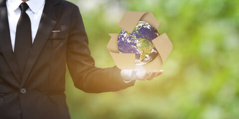 Canvas Print - world earth day concept. businessman show outstretched hand with earth and recycling symbol on green