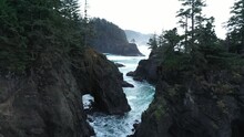 Flying Through The Rugged Coastline Of Oregon, A Landscape Shaped By The Waves Of Time.