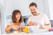 © unai - A Caucasian couple cooking together at home, cooking in confinement, cooking with the family. Coronavirus, covid-19. Cooking two lovers