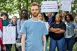 © Roman - young caucasian american guy is leading the group of BLM protestors. stop racism concept. people agitate to be tolerant and friendly
