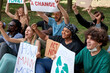 © Roman - mixed race environmental activists draw attention to climate change. protesting eco-activists with posters on demonstration in the park. saving Earth planet, ecology concept