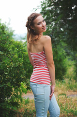 Wall Mural - The beautiful girl is walking outdoors. Girl in the park. Girl on nature. Woman outside. Positive woman smiling