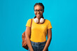 © Prostock-studio - Cheerful Black Millennial Girl Smiling Standing With Backpack In Studio