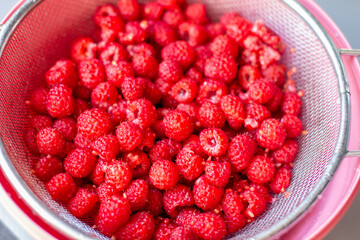 Poster - Red raspberry berry in a bucket. The view from the top
