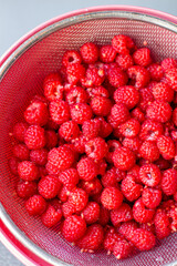 Poster - Red raspberry berry in a bucket. The view from the top
