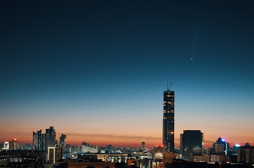 Nur-Sultan, Kazakhstan - July 13th 2020: C/2020 F3 NEOWISE comet over the Nur-Sultan city downtown at sunrise.