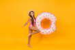 © be free - donut pool party. swimming pool at vacation. completely happy. child with inflatable rubber having fun on beach. childhood happiness. finally summer vacation. energetic small girl. Skin protection