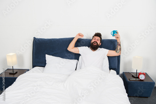 Recipe of perfect morning. Happy man enjoy morning coffee. Fresh coffee. Bearded man drink morning coffee. Man in bed. Good morning starts from coffee. Relaxing at home. Weekend relax. Self care