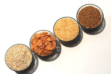 Wall Mural - Collection of legumes (Pigeon Peas, Fenugreek Seed, corn flakes) in different bowl isolated on white background.