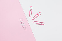 Top View Of White And Pink Paper Clips Arranged On Colorful Background Showing Concept Of Uniqueness