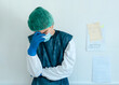 © Gabriel Trujillo/ADDICTIVE STOCK - Exhausted young medical worker in protective costume and mask with gloves standing near wall in hospital corridor while working hard during coronavirus pandemic